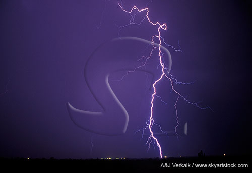 A looped and jagged cloud-to-ground lightning strike