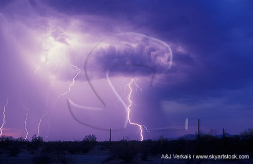 A burst of light brightens clouds while a subtle lightning bolt strikes