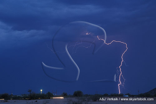 A single lightning bolt strikes in the twilight desert
