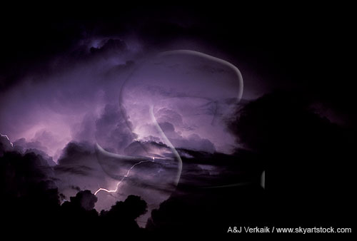 Intracloud lightning reveals cloud detail at the top of a storm