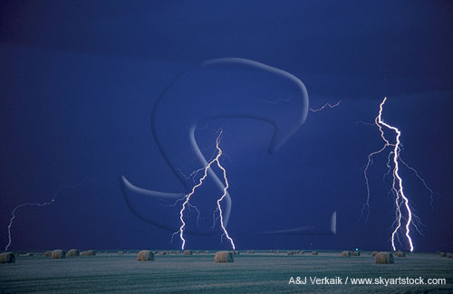 Lightning bolts with hay bales at twilight
