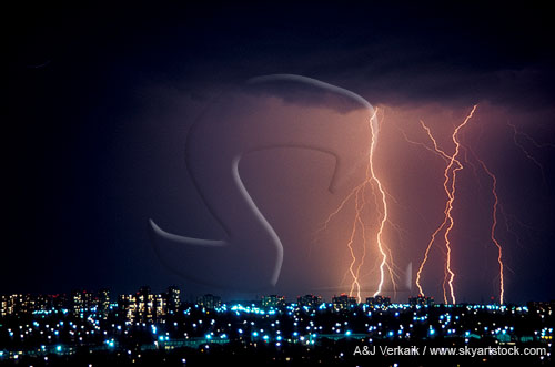 Cloud-to-ground lightning bolts over city skyline