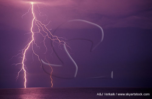 Close-up of a finely branched lightning bolt over water