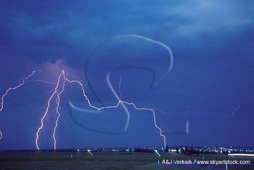 Lightning, out of the blue, as one bolts reaches out from the storm