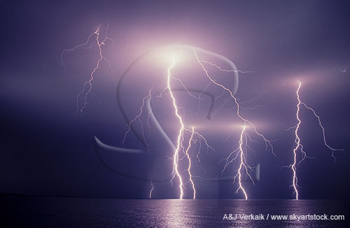 Lightning bolts with branches over water