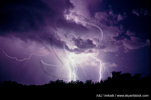Storm cloud illuminated by brilliant lightning