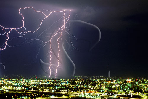 Close view of lightning bolts over a bright cityscape