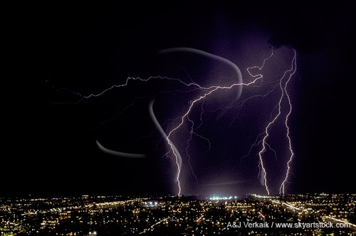 Lightning above city lights, viewed from a high point
