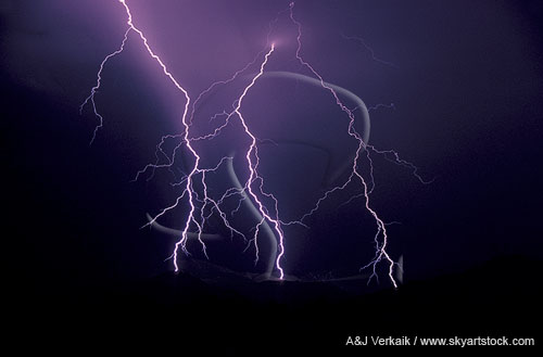A blitz of jagged cloud-to-ground lightning bolts at night