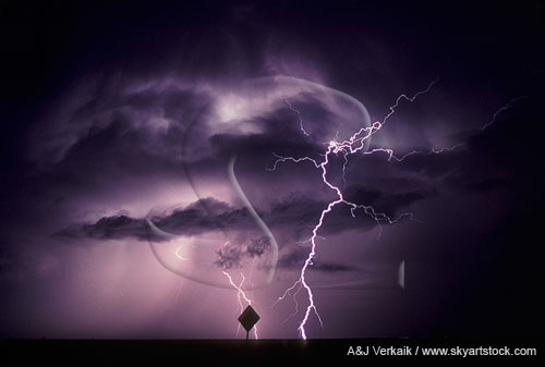 An anvil lightning bolt shoots out along an irregular path
