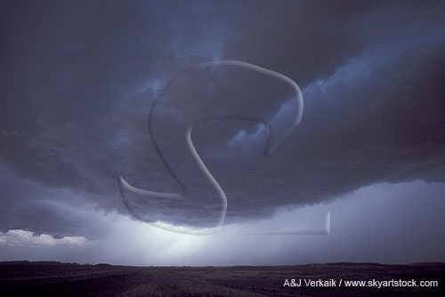 A low dark cloud arcs through the stormy sky
