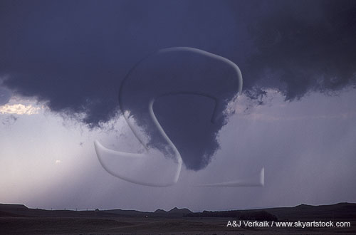 A tapered, funnel-shaped wall cloud extension