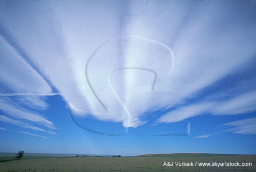 Milky smooth, sculpted streaks of cloud fan out across the sky
