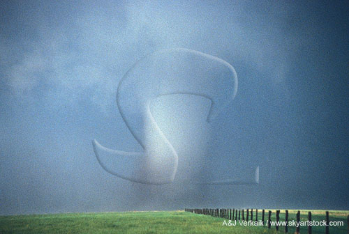A large and dangerous tornado with a murky swirl of debris