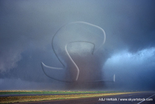 A wide wedge tornado surrounded by cloud tags in the wall cloud base
