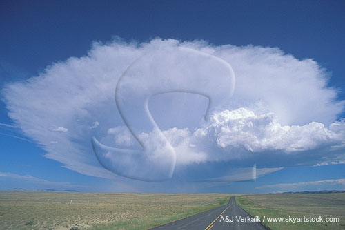 An isolated Cumulonimbus cloud down a lonely road