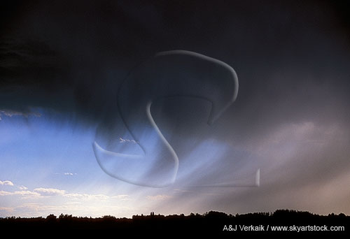 In this unusual weather photo wind shapes rain shafts