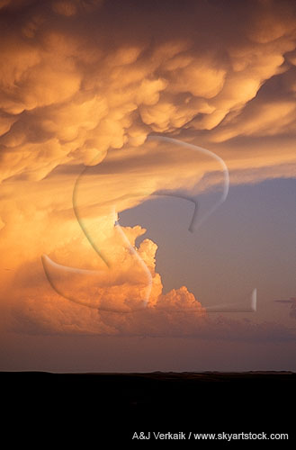 Enchanted skyscape: a storm cloud in the golden glow of sunset