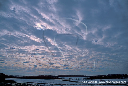 A woolly cloud sheet spreads a meditative light on a winter landscape