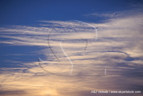 Cloud streaks in a twilight sky make for a serene silver abstract