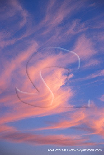 Cloud feathers glow deep pink at sunset