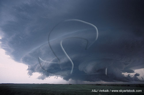 A beautifully sculpted wall cloud beneath a turbulent storm