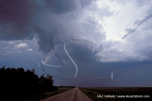 A snaky funnel cloud dangles from a storm