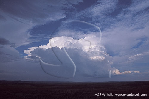 A boiling Cumulonimbus cloud glows in a rhythmic skyscape