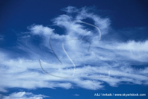 Playful cloud tufts and feathers dance in a bright blue sky