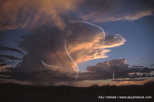 A Cumulonimbus storm cloud glows eerily in the sunset
