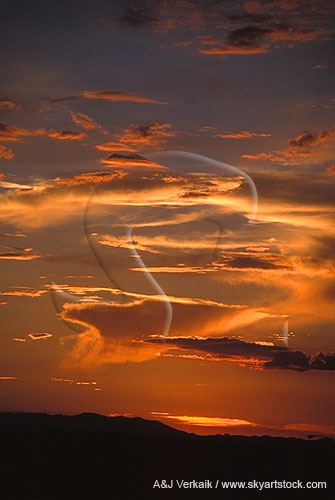 Streaks of gold-lined cloud in a dramatic red sunset