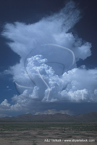 Boiling storm clouds burst upward 