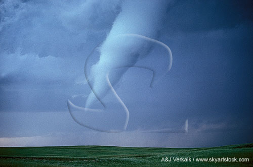 Tornado with condensation funnel threatening danger