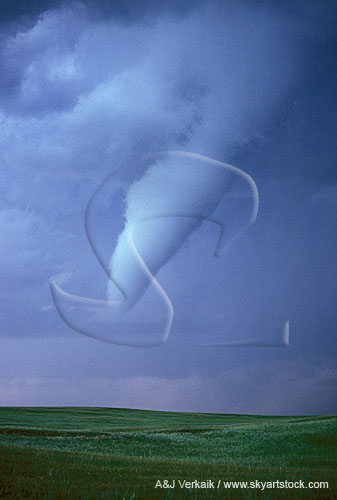A close tornado with condensation funnel hanging low