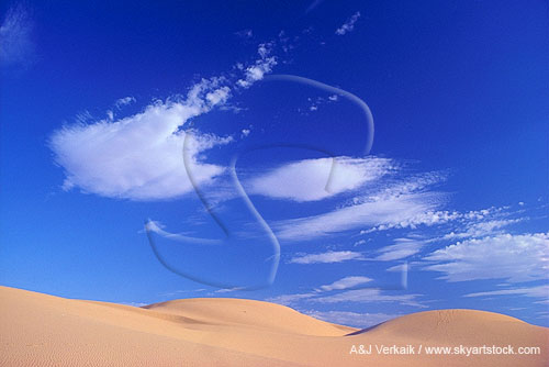 Lenticular Altocumulus clouds over desert sand dunes