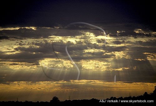 Golden crepuscular rays (rays of God) in a twilight sky