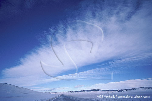 Winter skyscape in snow foothills with lee wave clouds