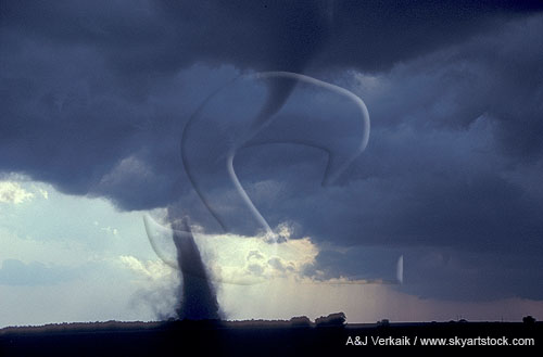 Tornado funnel made visible by stirred up dirt and condensation funnel