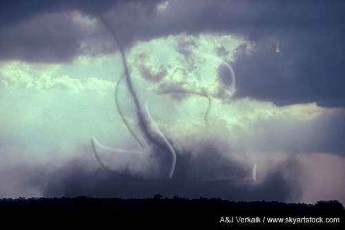 The dust cloud spreads as a tornado is roping out