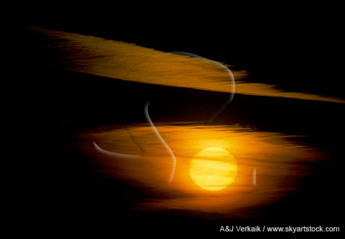 The sun disk glows orange in an eerie sunset