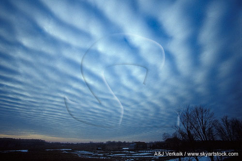 Luminous cloud billows in a winter landscape