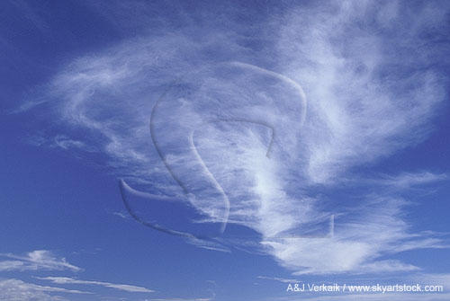 Clouds fan like angel wings in a blue sky