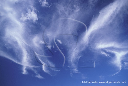 Fanciful clouds dance with joy in a blue sky.