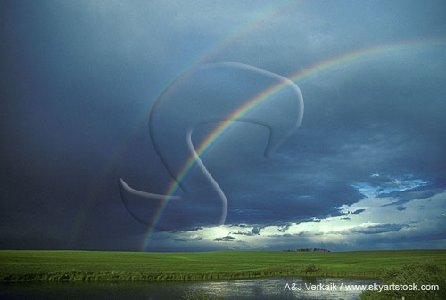 A double rainbow where sunshine strikes raindrops