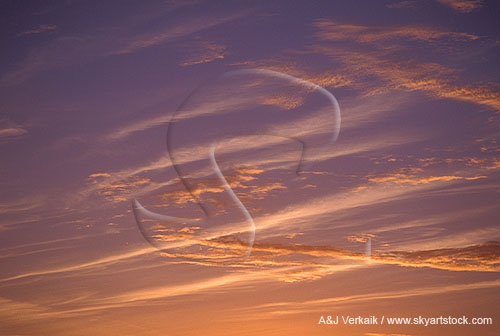 Delicate silver and bronze clouds in a mysterious sunset cloudscape