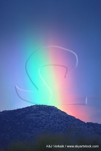 A heavenly rainbow with intense color spectrum on a mountain top