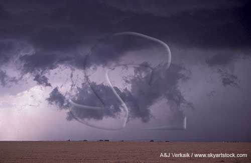 A large, wild-looking scud bomb at the edge of a heavy rain curtain