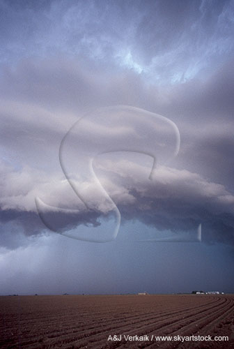 An arc of low cloud in a stormy sky