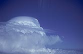 Pileus clouds drape the top of a storm in this aerial view