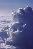 Towering Cumulus cloud viewed at eye level from an airplane